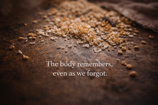 Close-up of scattered grains resting on a textured surface in soft light, creating a quiet and reflective mood.