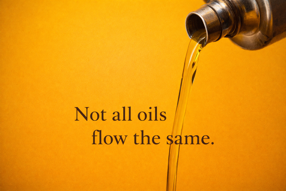 Cold-pressed oil flowing slowly from a traditional vessel, symbolising mindful food choices and natural nourishment